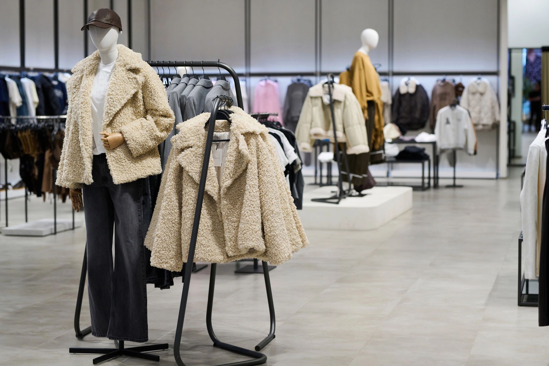 Modern apparel shop interior with neatly arranged clothing displays
